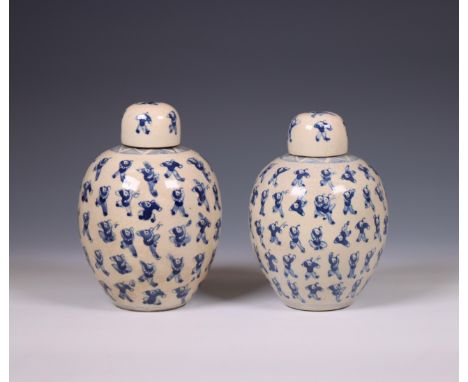 China, a pair of soft paste blue and white 'one hundred boys' jars and covers, 19th century, each painted with a pattern of b