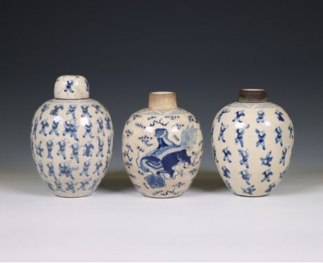 China, a pair of soft paste blue and white 'one hundred boys' jars and A 'buddhist lion' jar, 19th century, the pair painted 