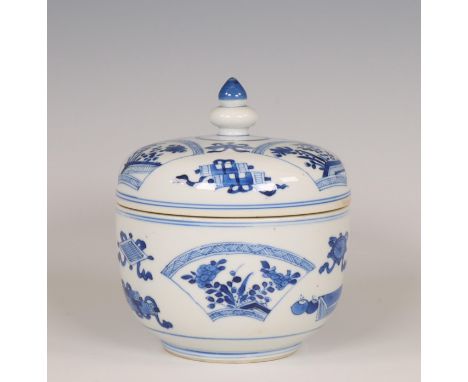 China, a blue and white porcelain box and cover, Kangxi period (1662-1722), decorated with buddhist symbols and fan-shaped pa