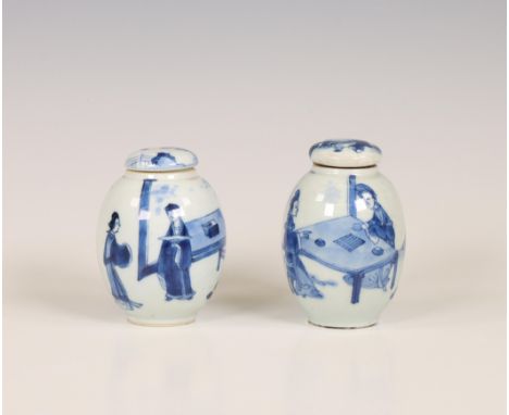 China, two blue and white porcelain tea-caddies and covers, Kangxi period (1662-1722), one painted with a couple playing weiq