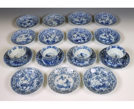 China, a set of four blue and white porcelain cups and fifteen saucers, Kangxi period (1662-1722), each moulded and painted w
