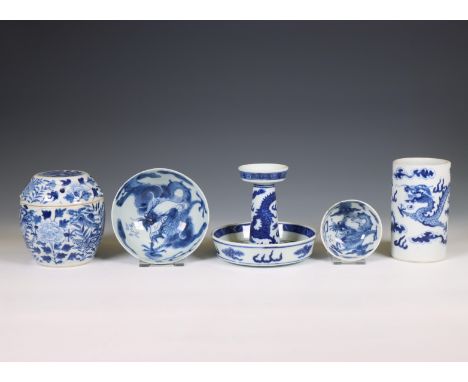 China, a collection of blue and white 'dragon' porcelain, 19th-20th century, comprising a candlestick, a vase, two bowls and 