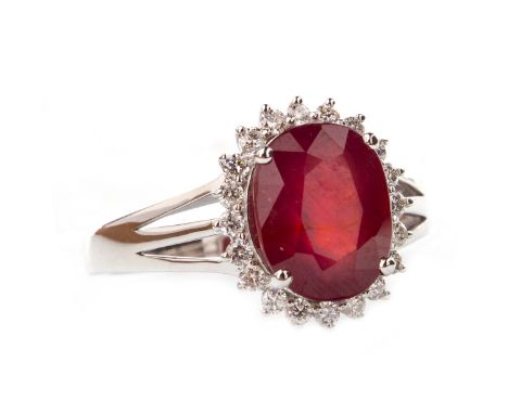 SPINEL AND DIAMOND RING, set with a central red oval faceted spinel 10x8mm, within a halo of round brilliant cut diamonds, on