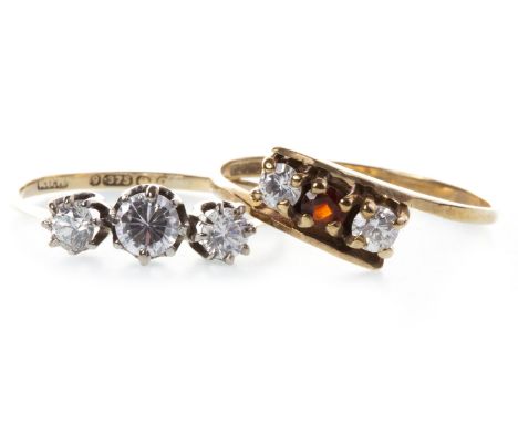 TWO GEM SET RINGS, one set with three round white gems, marked 375, size K, 0.9g, the other with a central red gem flanked by