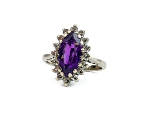 GEM AND DIAMOND RING, set with a central marquise shaped purple gem 11mm long and surrounded by diamonds, unmarked, size J, 4