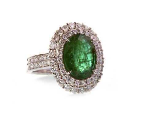 EMERALD AND DIAMOND CLUSTER RING, set with a central oval faceted emerald 12mm long within a double diamond halo, on diamond 