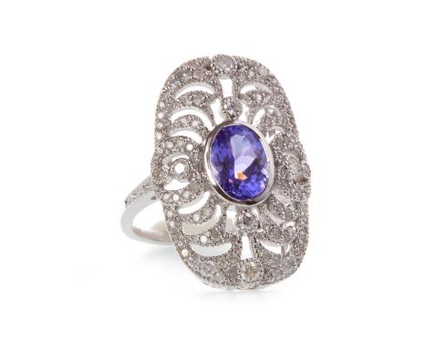 TANZANITE AND DIAMOND RING, the millegrain edged pierced plaque bezel 22.5mm long set all over diamonds, with a central oval 