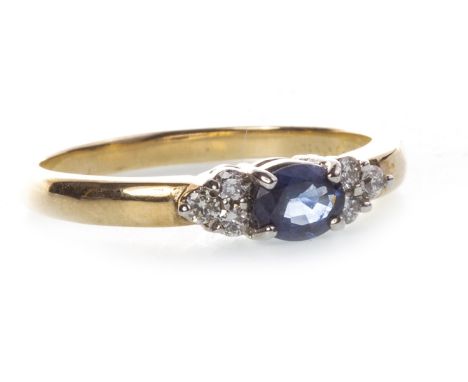 BLUE GEM AND DIAMOND RING, set with a central oval blue gem 4.7mm long, flanked by two groups of three diamonds, marked 375, 