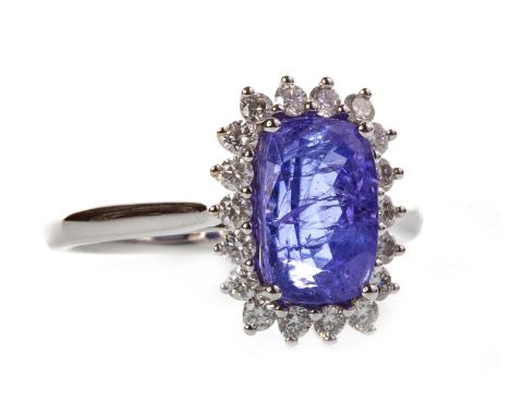 TANZANITE AND DIAMOND CLUSTER RING, set with a central rectangular faceted tanzanite 9.9mm long and surrounded by diamonds, m