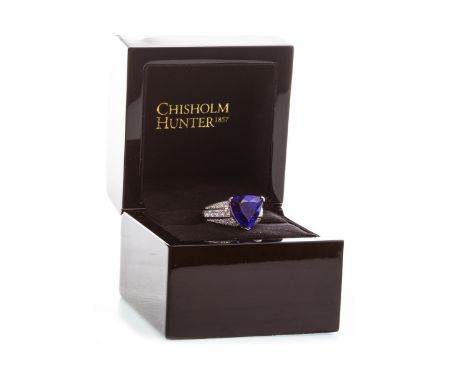 PURPLE GEM SET AND DIAMOND RING, the central trilliant cut purple gem 11.8x12.1mm, on princess and round brilliant cut diamon
