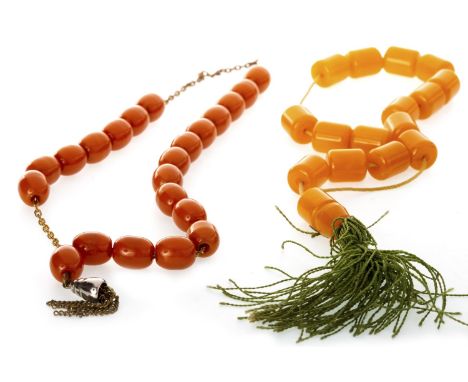 BEAD NECKLACE AND A SET OF PRAYER BEADS, one possibly in butterscotch amber, each bead 11.5mm long, on a metal chain, 23g gro