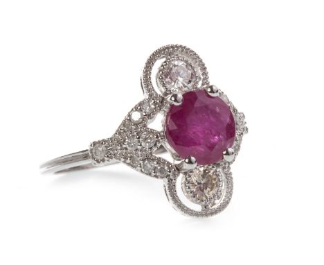 RUBY AND DIAMOND RING, the open bezel set with a central round faceted ruby 6.4mm diameter and flanked by two round brilliant