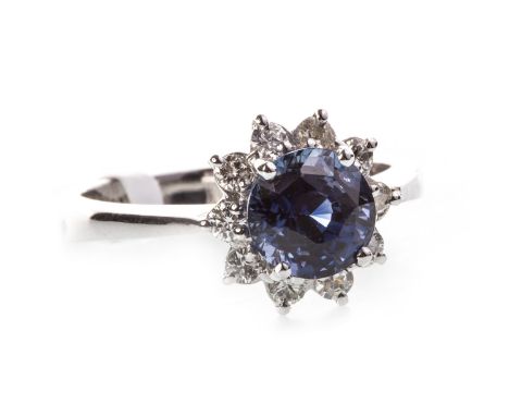 SAPPHIRE AND DIAMOND CLUSTER RING, set with a central round faceted sapphire 6.9m diameter and surrounded by round brilliant 