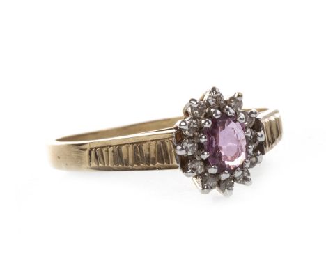 RED GEM AND DIAMOND CLUSTER RING, the central oval red gem surrounded by round brilliant cut diamonds totalling approximately