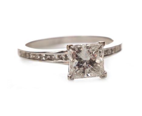 DIAMOND SOLITAIRE RING, set with a princess cut diamond of approximately 1.50 carats, with channel set princess cut diamonds 