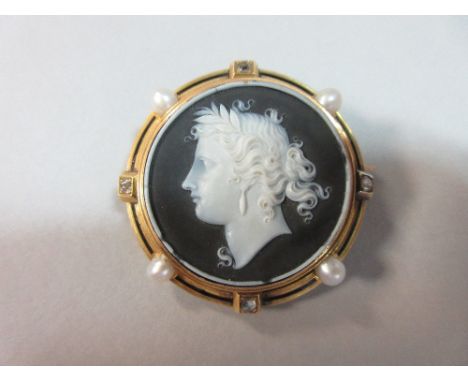 A French hardstone cameo brooch in 18ct gold, diamond, pearl and enamel mount, the circular finely carved black and white cam