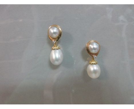 A pair of mabé pearl and diamond earrings with removable South Sea pearl drops, each with a 10mm diameter mabé pearl collet s