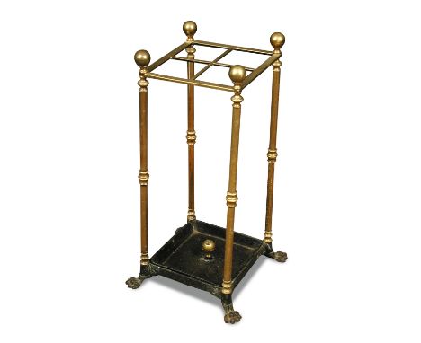 A patent brass stick stand, late 19th century, with drip tray, on cast iron lion paw feet, Rd no 396125 65 x 25 x 25cm (25 x 