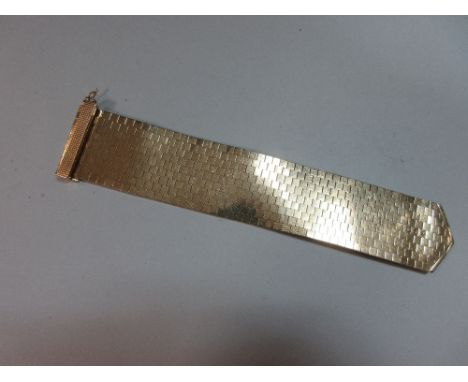 A 9ct gold jarretière bracelet, designed as a uniform width cuff of smooth polished and close set brick links with a bound ch