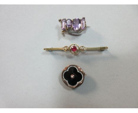 Three antique gem set brooches, the first a ruby and seed pearl bar brooch stamped '15ct', central ruby 5.0mm diameter; the s