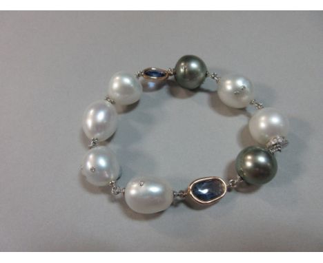 A contemporary South Sea pearl, diamond and iolite bracelet, comprising two grey and six white pearls of slightly irregular s