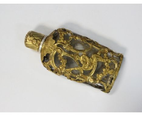 A 19th century yellow metal clad scent bottle, with clear cut glass liner, the cage cladding of open chinoiserie, the fluted 