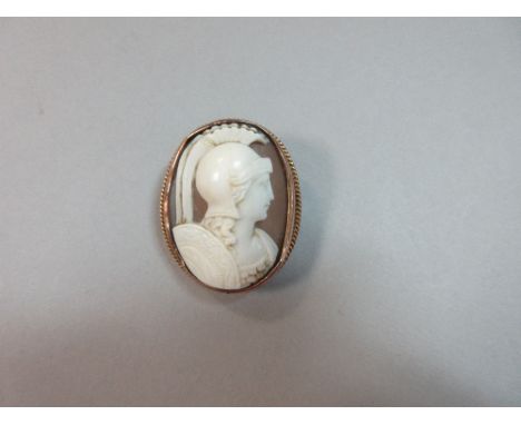 A shell cameo brooch depicting the bust of a classical warrior, the young man - or youthful god, Mars - wearing a plumed and 