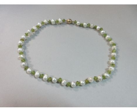 A peridot and pearl necklace, with alternating polished bouton peridots and 8mm freshwater pearls, all individually knotted, 