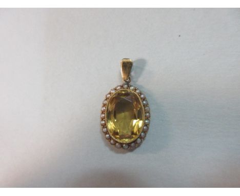 A citrine and seed pearl pendant, the oval cut golden yellow citrine millegrain collet set to a lowered border of 1.5mm mushr
