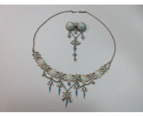 A Norwegian enamel and washed silver filigree necklace and matched brooch, the necklace comprising different flower motifs, s