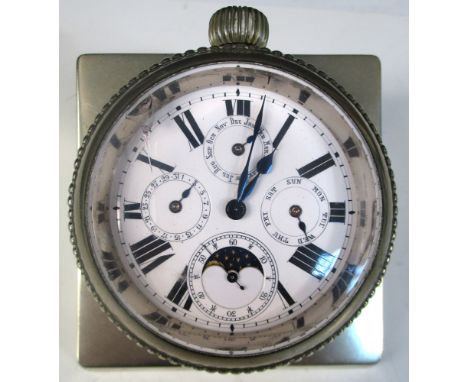 Unsigned - a metal paperweight watch, of wedge shape incorporating an outsize keyless calendar watch with white enamel dial w