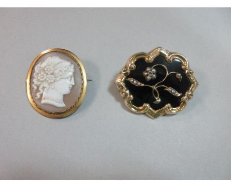 A Victorian memorial brooch and a cameo brooch, the first with an undulating outline of a scrolling and bright cut frame arou