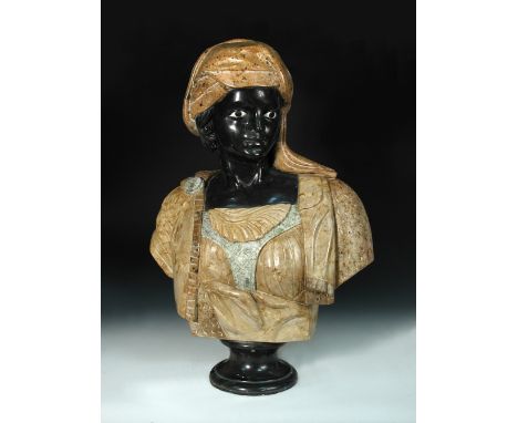 A specimen marble portrait bust of a Nubian, mounted to a socle and spreading circular foot 68cm (27in)  