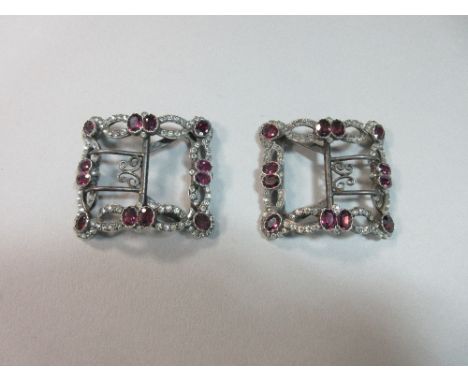 A pair of French 18th or 19th century silver, garnet and white paste shoe buckles, each rectangular, and set around the edge 