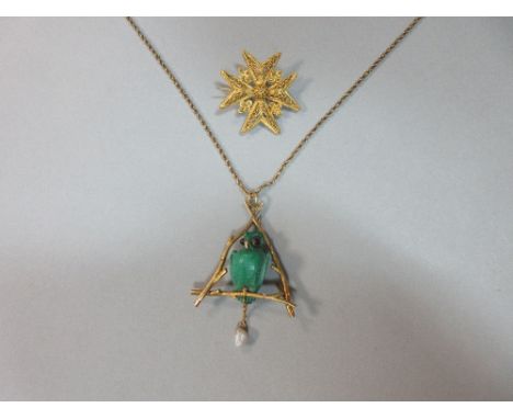 A carved malachite owl pendant with chain, together with a gold filigree maltese cross brooch, the pendant designed as a real