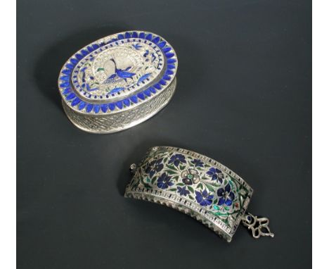 A late 19th century Indian silver box, of oval form, the body diaper engraved, the cover engraved with the figure of a peacoc