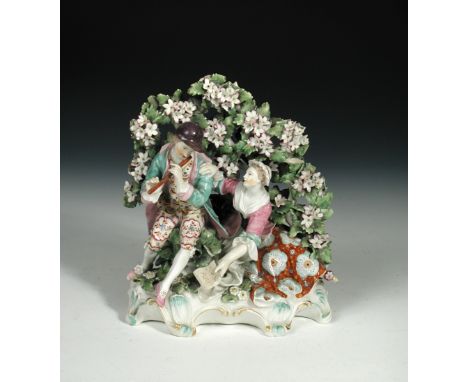 An 18th century Derby patch mark arbour group, modelled as a courting couple, she seated holding sheet music whilst her comap