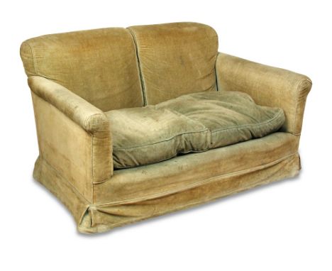 A small two seat sofa in the manner of Howard, early 20th century, with loose cushions to the gently bow front seats, on tape