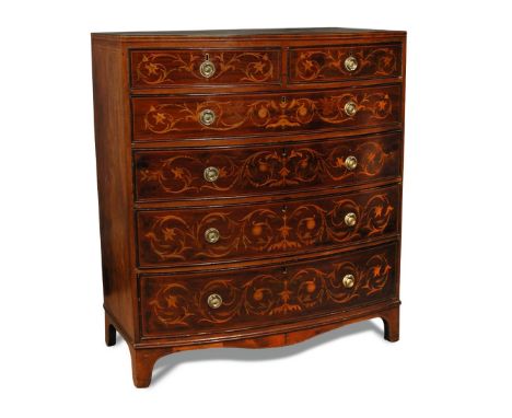 A Regency mahogany bow front chest of drawers, in the manner of Edwards & Roberts, inlaid with acanthus scroll, brass ring ha