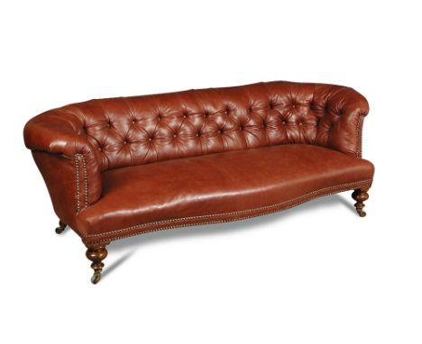 A Victorian tan leather chesterfield, button upholstered back with a seat of serpentine outline, on turned legs and casters 6