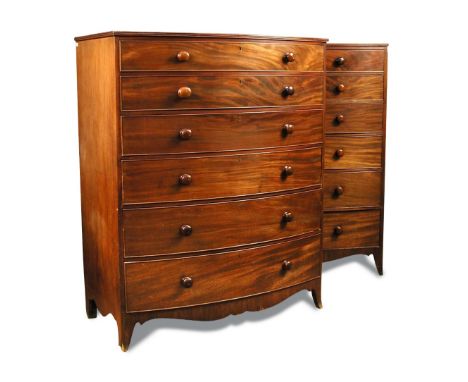 A pair of Regency mahogany bow front chests of seven drawers, with reeded border moulding, turned handles and on swept bracke