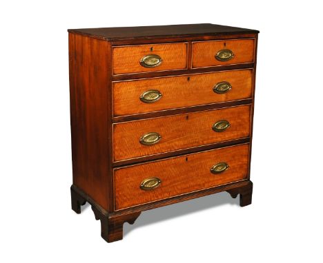 A George III mahogany Chest of Drawers, 'fiddle back' mahogany drawer fronts, with brass oval handles, on bracket feet 101 x 