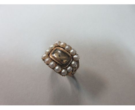 A late Georgian or William IV memorial swivelling ring, the central swivelling rectangular panel of plaited hairwork, verso w