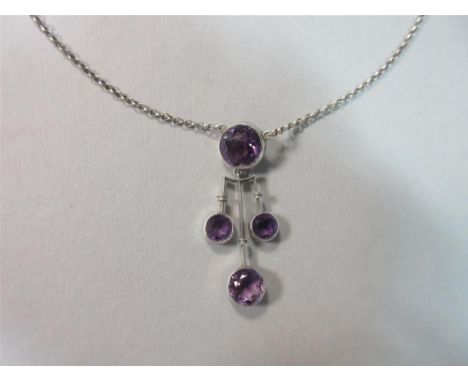 An amethyst pendant necklace, the central feature with a collet set round cut amethyst suspending a trident with banding deta