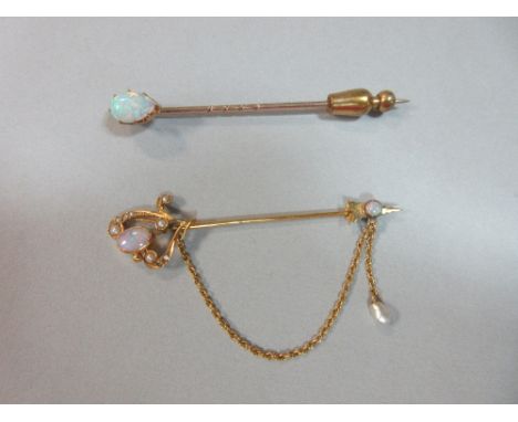 An antique opal and pearl cloak pin together with an opal set stick pin, the cloak pin with an asymmetric heart form set with