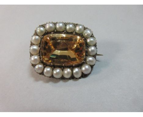 An early 19th century citrine and pearl brooch, of large lace pin form, the rectangular cushion cut pale apricot yellow citri