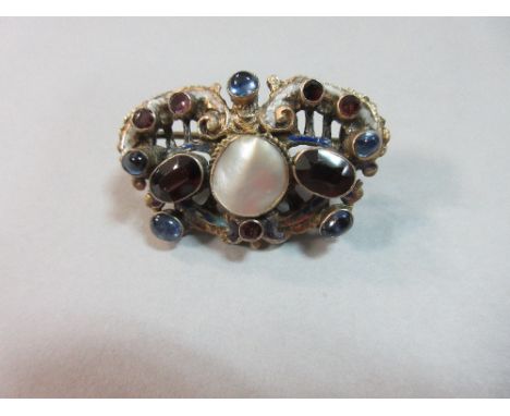 An Austro-Hungarian blister pearl, multi gem and enamel brooch, of pierced oval form with a central round blister pearl betwe