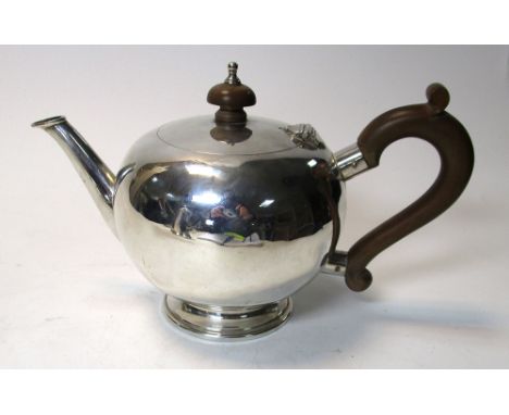 An 18th century style silver bullet shaped bachelor's teapot, by Collingwood & Co, London 1968, the plain body raised on a mo