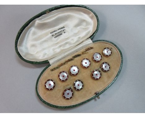 A red hardstone, red enamel and mother-of-pearl gentleman's dress set, the double-ended cufflinks designed as mother-of-pearl