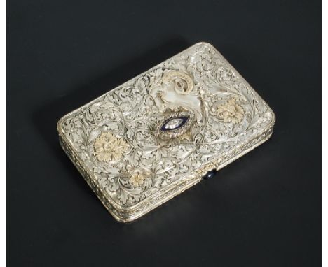 A continental silver snuff box, unmarked and of rectangular shape, heavily chased with the mask of Pan amidst scrolling folia